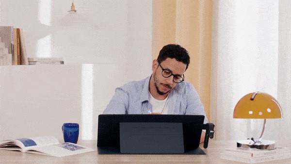 Мужчина работает за настольным ковриком MOFT Smart Desk Mat с планшетом и телефоном